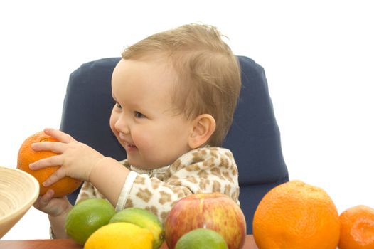 Baby and fresh fruits on table isolated background