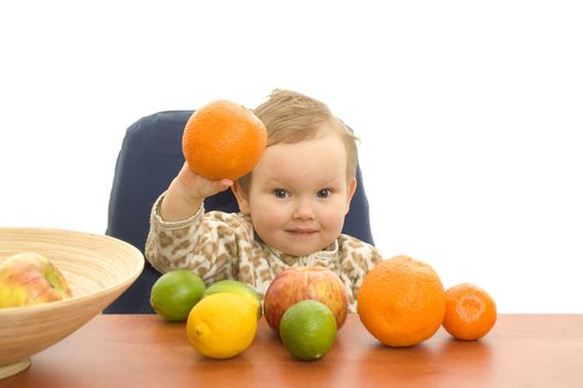 Baby and fresh fruits on table isolated background