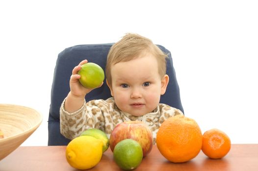 Baby and fresh fruits on table isolated background