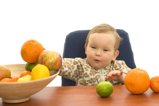 Baby and fresh fruits on table isolated background