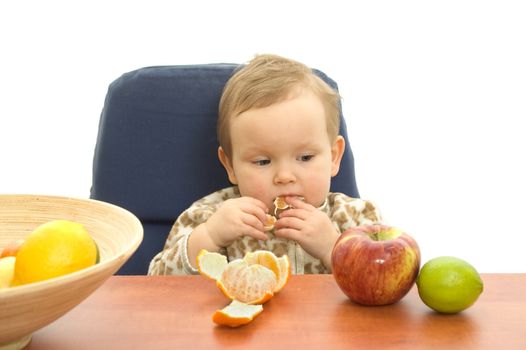 Baby and fresh fruits on table isolated background