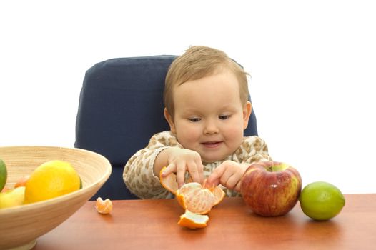 Baby and fresh fruits on table isolated background