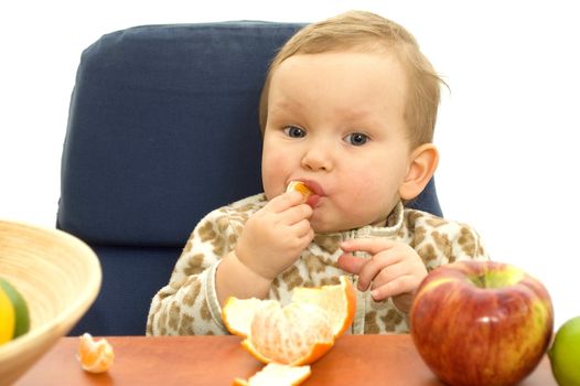 Babby eat fruit on table isolated background