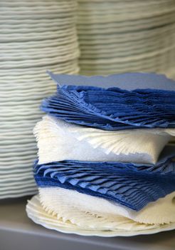 Dark blue both white napkins and pile of plates