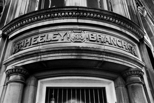 A photograph of intricate and beautiful stonework dated 1900 in an old bank.