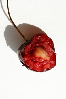 Half of berry of a sweet cherry on a white background