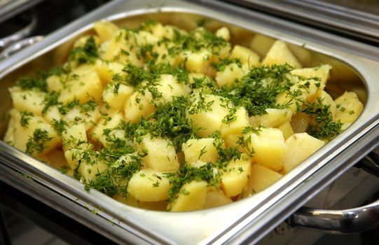 Cooked potato with fennel in a metal saucepan