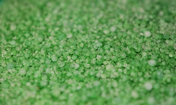 A close up photograph of green granules