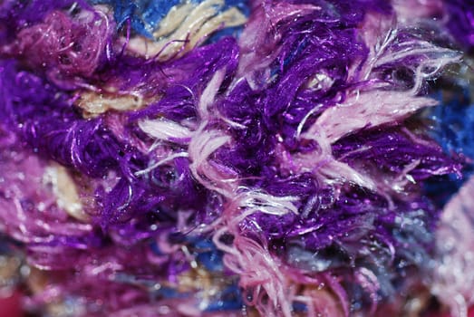 A macro photograph of colourful fibres, abstract and ideal for a cheerful background.