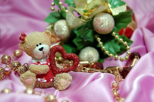 Bear figurine with red heart and Christmas decoration