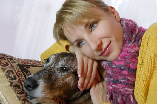 girl sitting in chair and embrasing dog