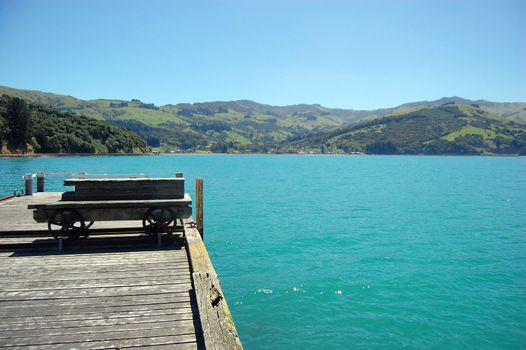 Old trolley at timber pier, Banks Peninsula, New Zealand