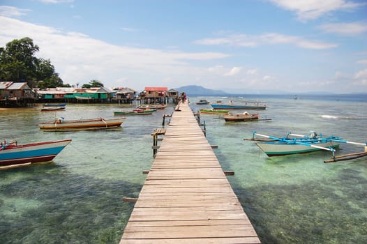 Long timber pier and boats, Jayapura, Indonesia