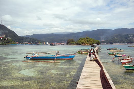 Fishermen with net at timber pier, Jayapura, Indonesia