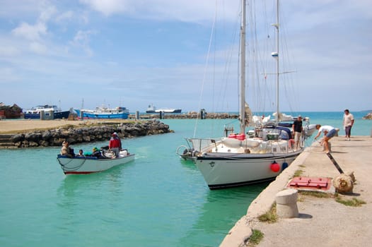 Yacht and fishing boat at port, South Pacific, Tonga