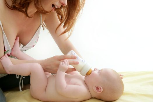 nude blond baby playing mother hands together