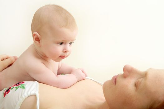 baby nude blond on mother arms white background