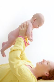 mother holding nude baby playing white background