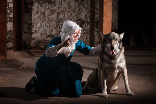 Middle ages nun dog owner talking to her pet