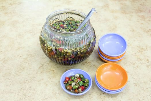 Hot Cut Chili Peppers with Soy Sauce in Glass Jar and Served on Little Dishes