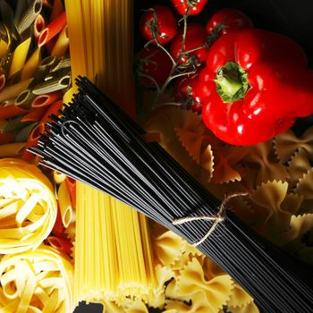 Pasta ingredients on black table, italian cuisine concept