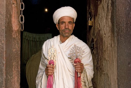 priest at ancient rock hewn churches of lalibela in ethiopia