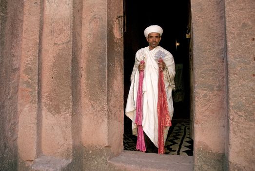 priest at ancient rock hewn churches of lalibela in ethiopia