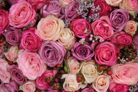 Pink and purple roses in a wedding flower arrangement