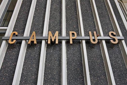 campus sign on the steel rails and concrete wall