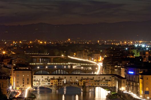 Ponte Vecchio (Old Bridge) in Florence Firenze over Arno River, Italy at night