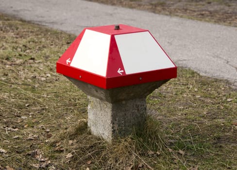 direction sign outside in red and white