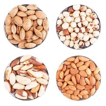 Assorted nuts on a flat plate, isolated on white