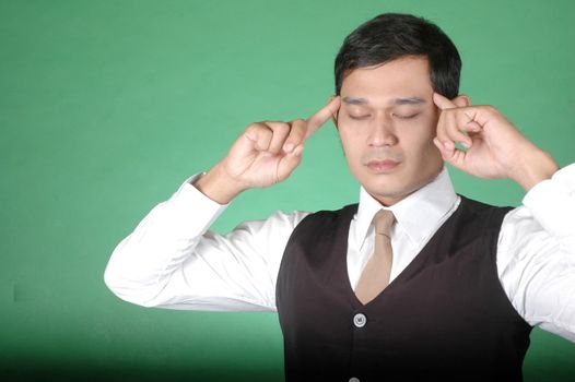 asian young man with posture was thinking against green background