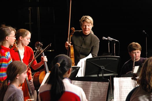 Teacher performing with string ensemble on stage.  Photo taken May 5, 2005.