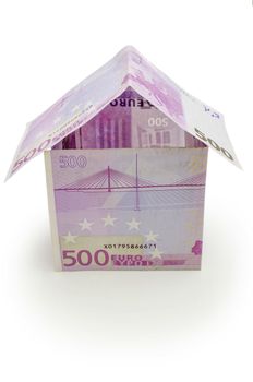 House made of  money. Isolated on a white background.