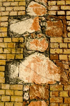 Architectural old wall background. Interesting architecture made of different bricks. Cross sign.