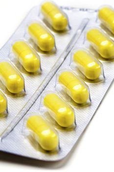 Pack of medical capsules on white.