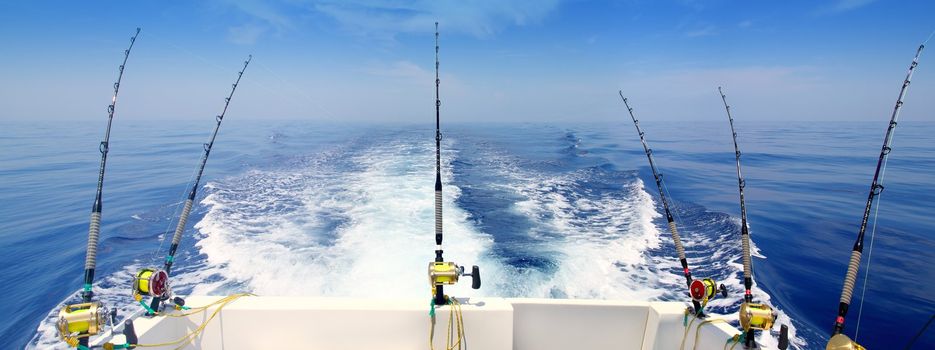 boat fishing trolling panoramic rod and reels blue sea wake