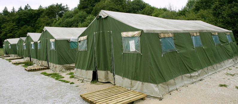 Green big tent camp pattern in Pyrenees for Santiago pilgrims