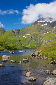 Scenic lake with waterfall on Lofoten islands in Norway on summer day