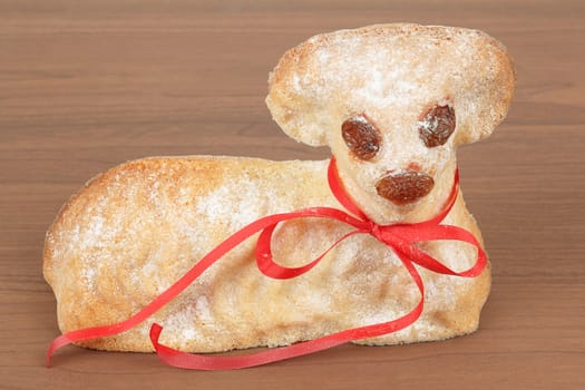 Easter lamb with powdered sugar isolated on wooden background