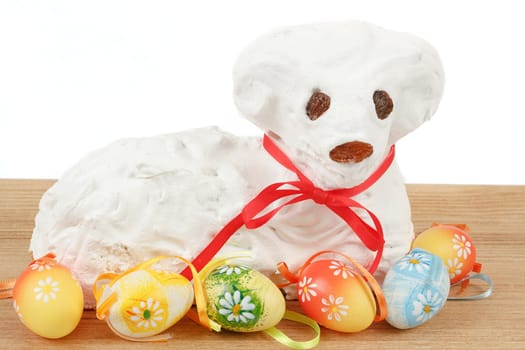 white easter lamb with painted eggs on white background