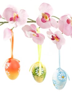 hanged bright color easter eggs with bows on spring flower isolated on white background