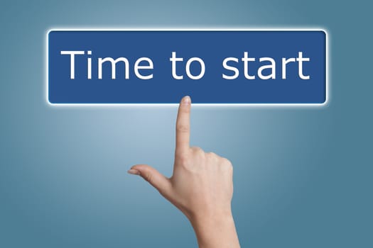 Woman hand pressing a button with word " Time to start " on blue background