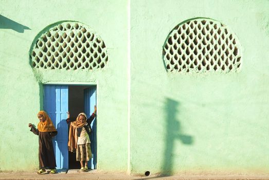 veiled girls by mosque in harar in ethiopia