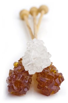 Candy brown and white sugar on a sticks. With white background. Soft focus.