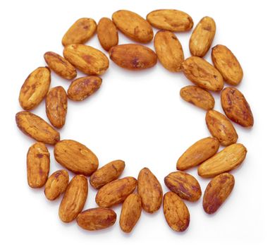 Raw cacao beans arranged in circle shape. Isolated on white background.