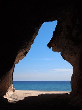 View on the mediterranean sea from a cave at Cala Luna beach in the Gulf of Orosei on Sardinia, Italy.