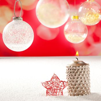 christmas silver candle and red star on snow and red with glass baubles