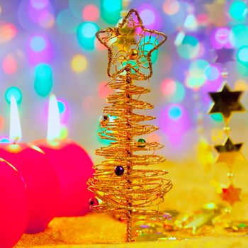 Christmas golden tree with baubles and candles in blur lights